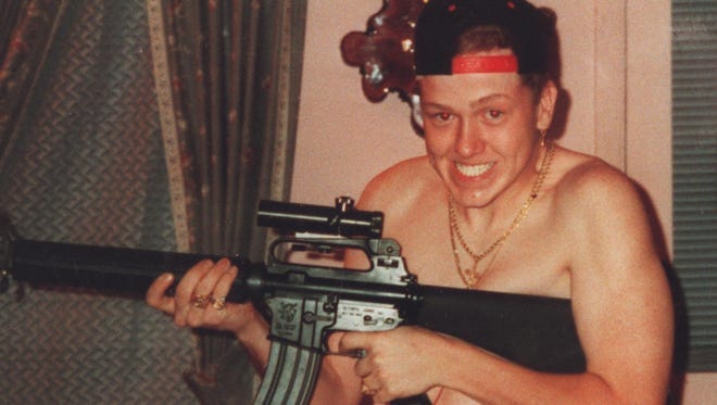 Kevin Foster brandishes the AR-15 semiautomatic. Kevin Foster brandishes the AR-15 semiautomatic.