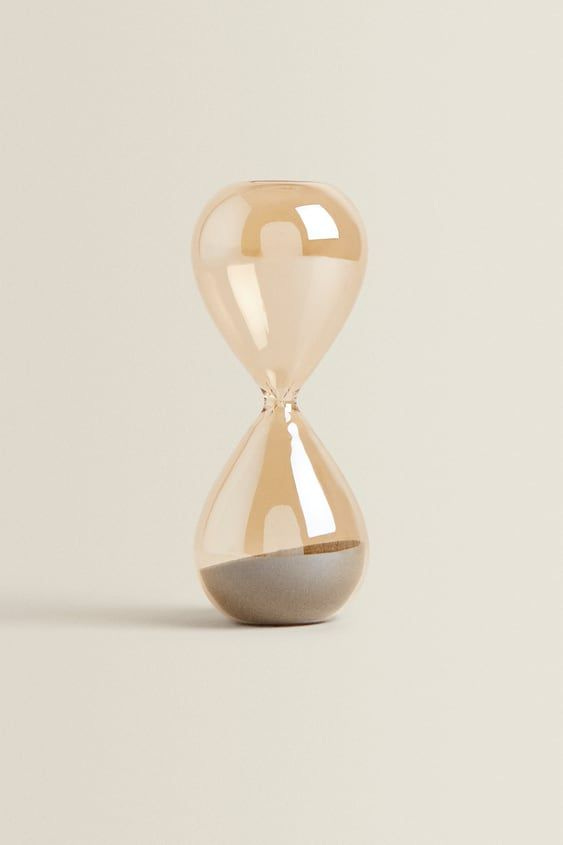 This may contain: an hourglass sitting on top of a table This may contain: an hourglass sitting on top of a table