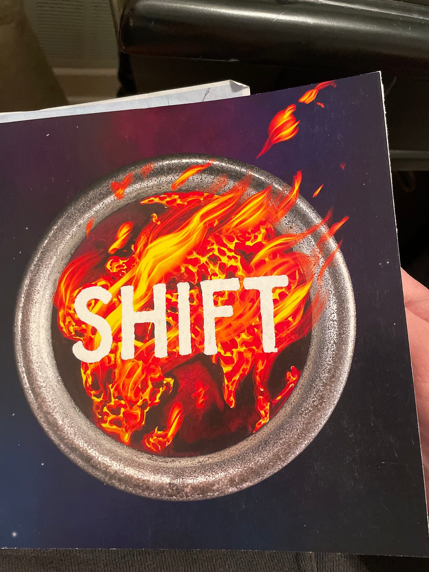 a lit mag with a blue cover and a ring of fire with the word SHIFT emblazoned across a lit mag with a blue cover and a ring of fire with the word SHIFT emblazoned across