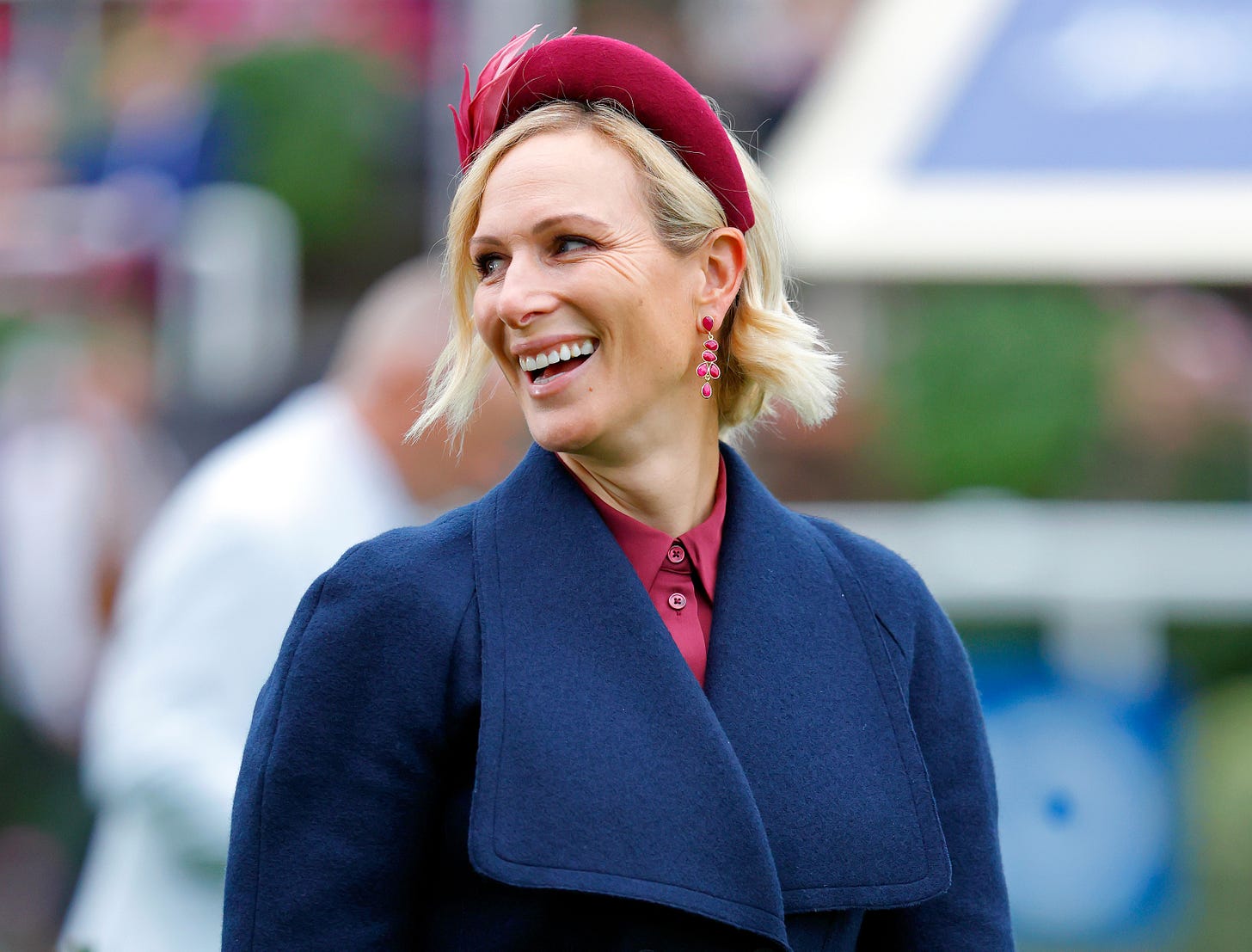 Zara Tindall in a blue jacket and pink hat Zara Tindall in a blue jacket and pink hat