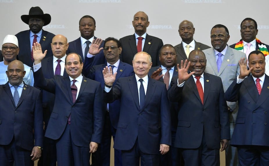 Men waving in a group photograph. Men waving in a group photograph.