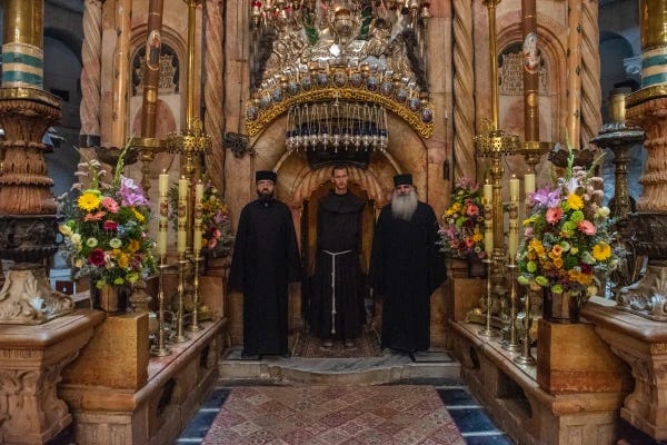 Os sacristãos das três comunidades que guardam a Basílica do Santo Sepulcro em Jerusalém — ortodoxos gregos, católicos latinos e armênios — estão em frente à porta da edícula que contém o túmulo venerado. Crédito: Marinella Bandini Os sacristãos das três comunidades que guardam a Basílica do Santo Sepulcro em Jerusalém — ortodoxos gregos, católicos latinos e armênios — estão em frente à porta da edícula que contém o túmulo venerado. Crédito: Marinella Bandini