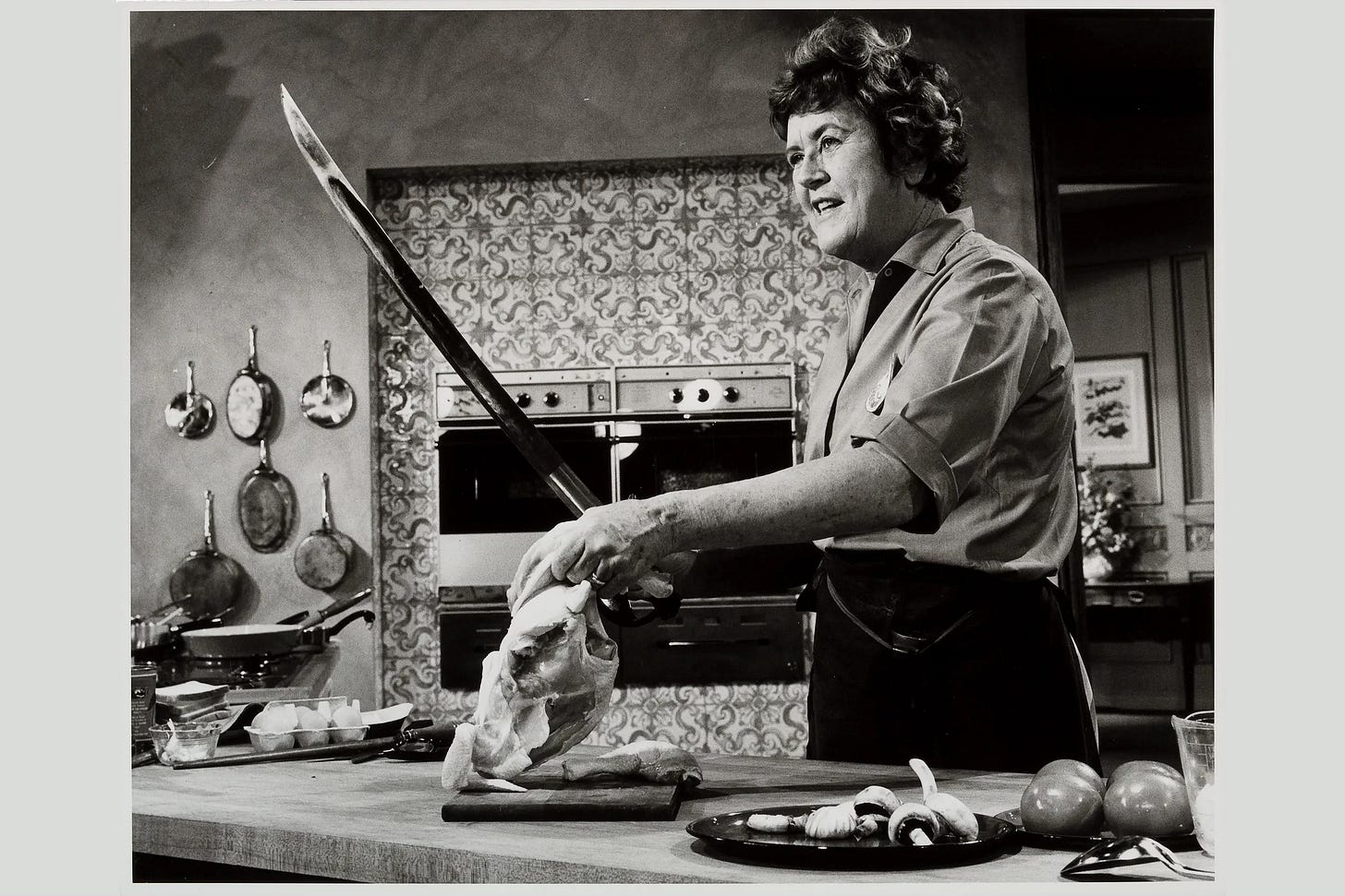 Julia Child's with a giant sword cutting a chicken