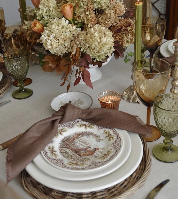 This may contain: the table is set with plates and silverware