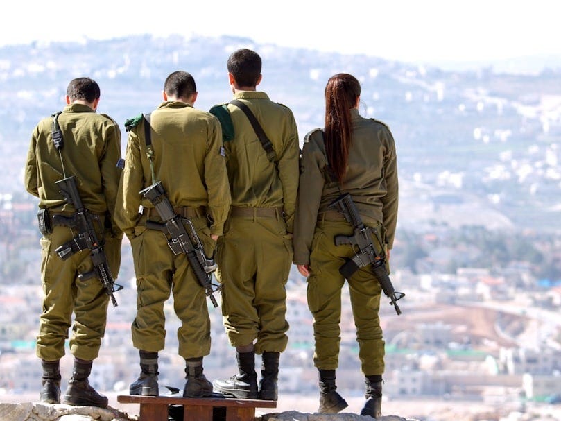 three men and one woman soldiers standing on rock during daytime