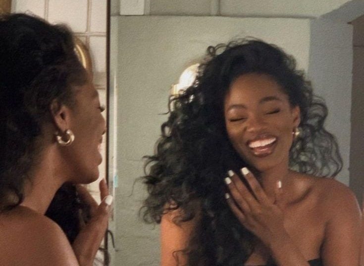 This may contain: a woman brushing her teeth in front of a bathroom mirror and looking at herself in the mirror This may contain: a woman brushing her teeth in front of a bathroom mirror and looking at herself in the mirror