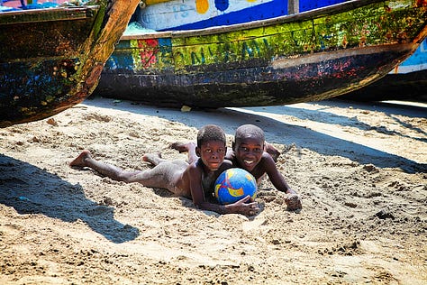 Canoes, boys, girls, pier at James in Accra, Ghana