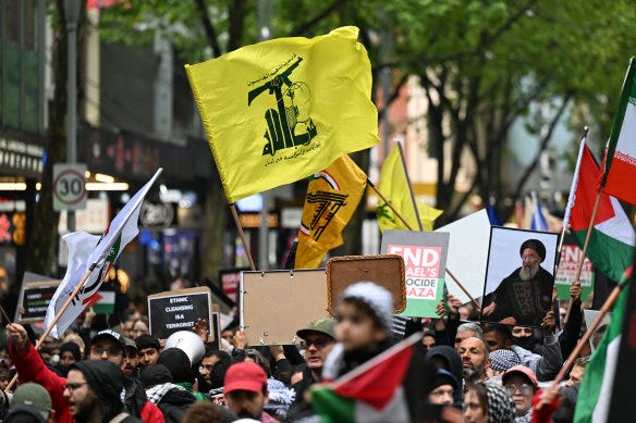 A Hezbollah flag is seen during the pro-Palestine rally for Gaza and Lebanon at the State Library of Victoria.