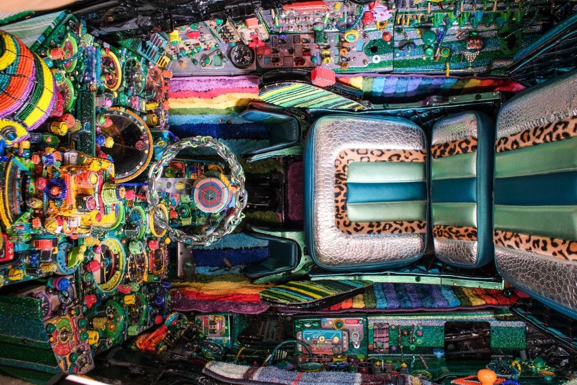 The cockpit of the MiG-21 installation was a crossover of pan-African beadwork and an inspiration much closer to Ziman’s current home: Los Angeles lowrider culture. The team removed the jet’s joystick and fitted a steering wheel, and added a faux-leopard and crocodile skin seat. The cockpit of the MiG-21 installation was a crossover of pan-African beadwork and an inspiration much closer to Ziman’s current home: Los Angeles lowrider culture. The team removed the jet’s joystick and fitted a steering wheel, and added a faux-leopard and crocodile skin seat.