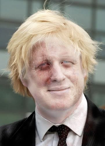 A middle aged man with blonde hair and zombie make up, smirking.