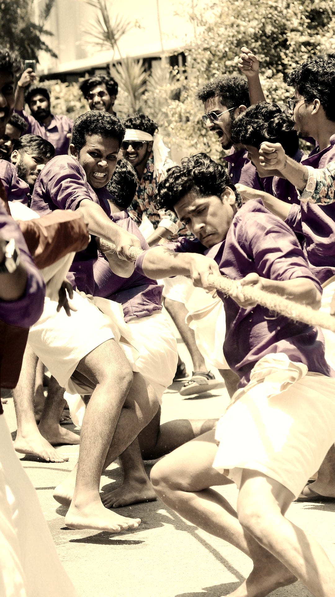 group of men pulling rope during daytime group of men pulling rope during daytime
