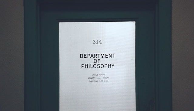 This may contain: a door with a sign on it that says department of the philosoy in black and white