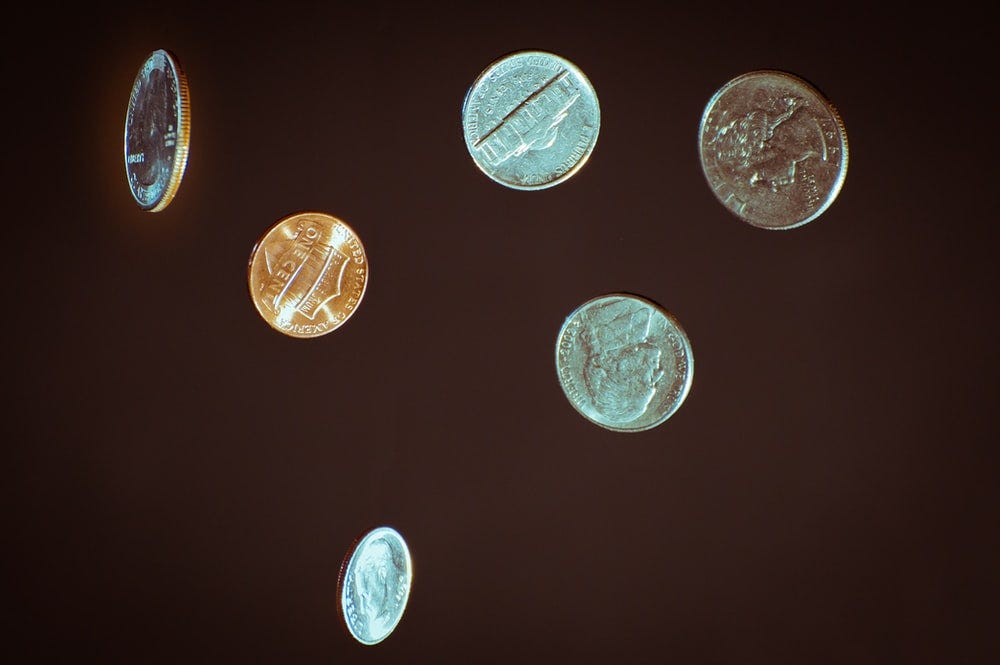 silver round coins on white surface silver round coins on white surface