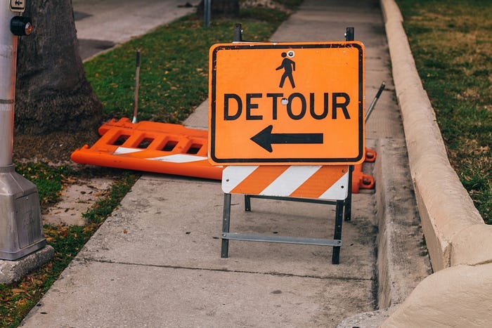An orange sign signalling a detour An orange sign signalling a detour