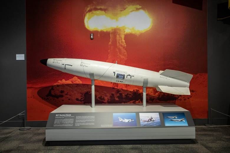 The image depicts a display of the B57 Nuclear Bomb, showcased on a pedestal against a red backdrop.

AI-generated content may be incorrect.