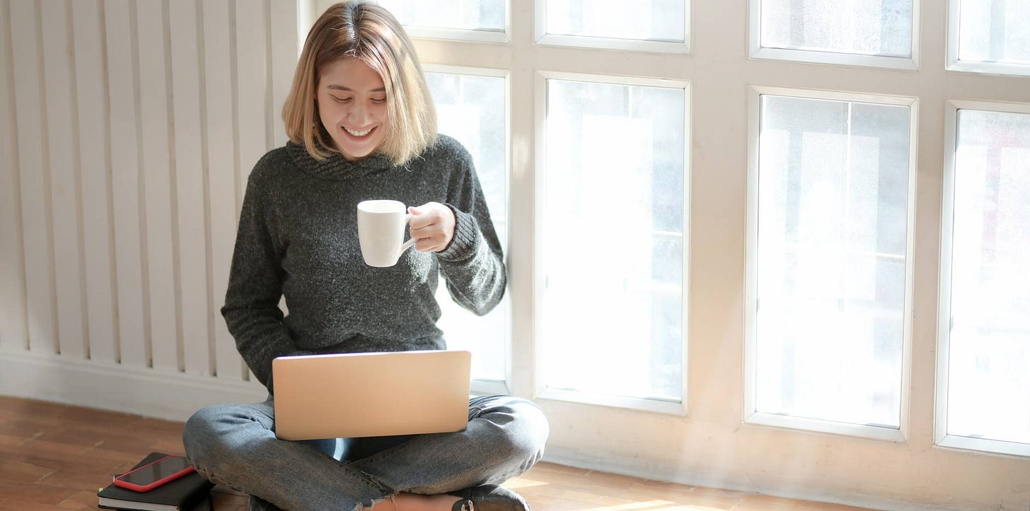 woman in gray sweater drinking coffee woman in gray sweater drinking coffee