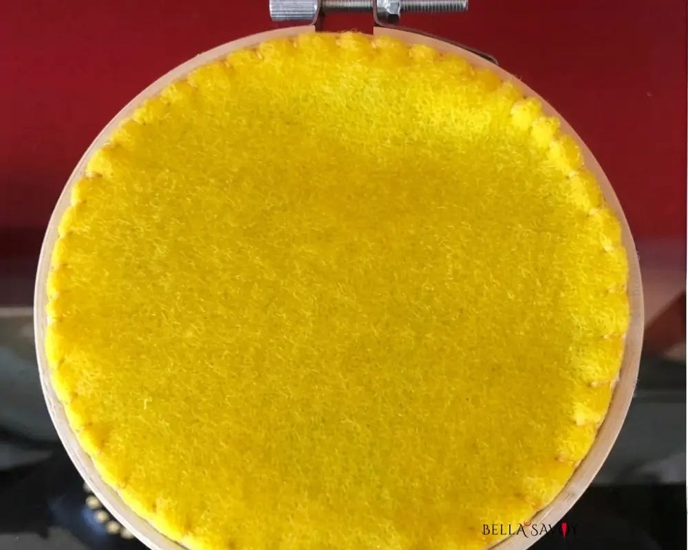 finished embroidery hoop with yellow felt