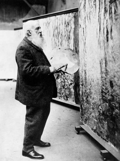 Painter Claude Monet at work for the monumental painting Nympheas in his studio in Giverny circa 1918.