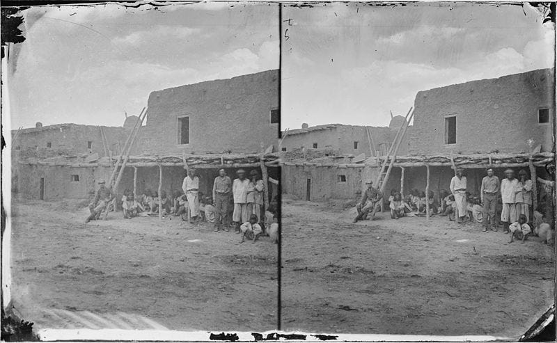 Zuni Indians and two white men.
