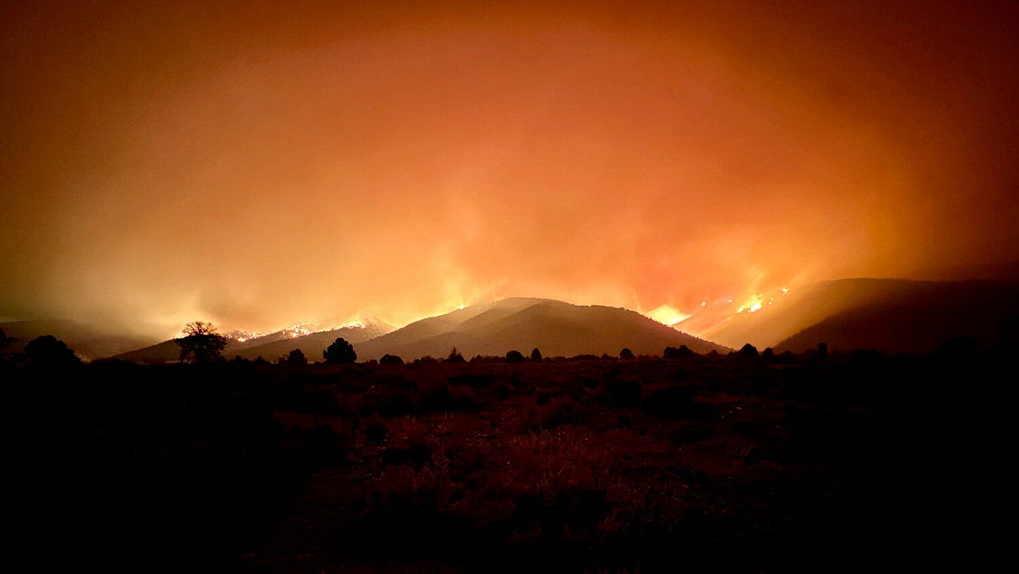The Iron Fire's smoke columns, sunset glow and night sky seen from the north side of the fire in Ju...