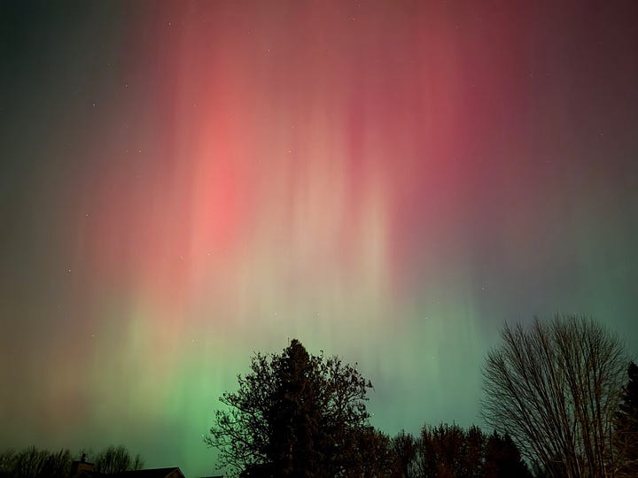 two pictures of the Northern Lights, pink and green shimmering in night sky