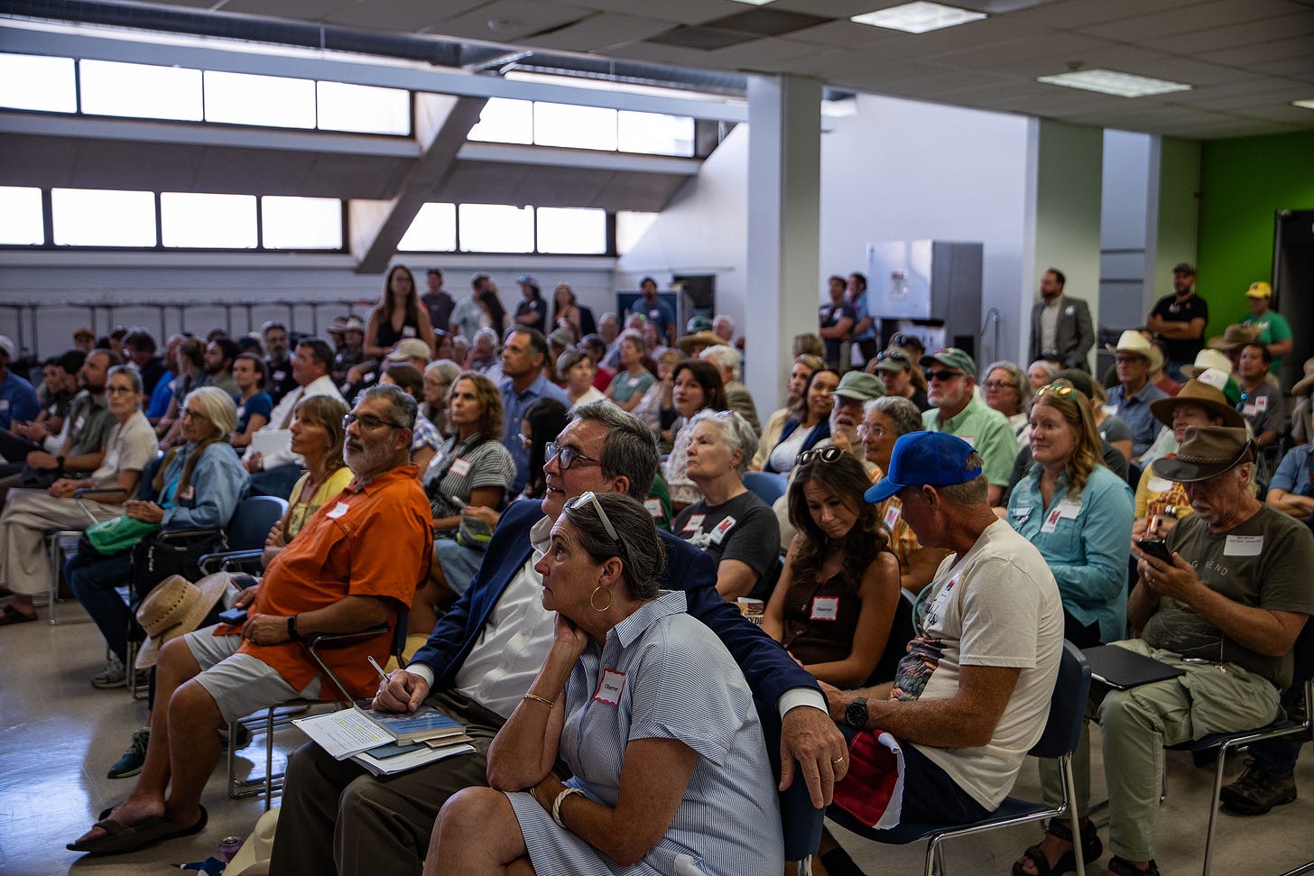 The audience, including dozens who signed up to address the commission in opposition to border infrastructure projects in the Big Bend region, listens as the Texas Parks and Wildlife Commission public meeting begins in Austin on Aug. 18, 2026. (Photo by Kaylee Greenlee for the Texas Tribune) The audience, including dozens who signed up to address the commission in opposition to border infrastructure projects in the Big Bend region, listens as the Texas Parks and Wildlife Commission public meeting begins in Austin on Aug. 18, 2026. (Photo by Kaylee Greenlee for the Texas Tribune)