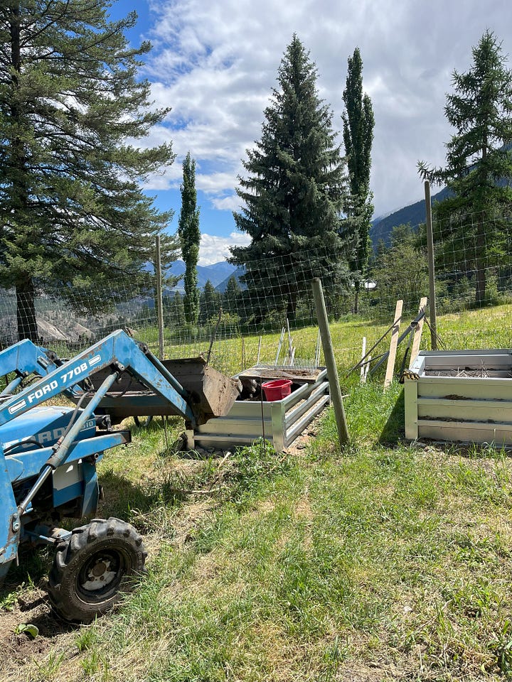tractor bring soil to a raised bed; garden area dug over by a tractor