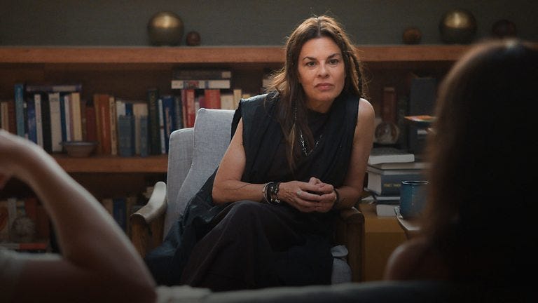 Orna, the therapist from Couples Therapy, sitting across from clients we can only see blurred. She's leaning forward, listening intently.