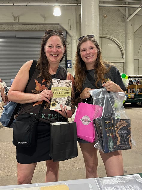 two women holding books, author at table with books, book fair for grownups promo poster