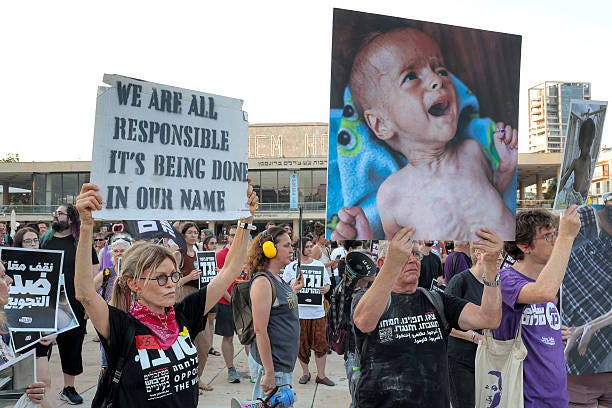 Israeli activists gather at HaBima Square for a protest march towards the Israeli defence ministry headquarters in Tel Aviv on July 22, 2025...