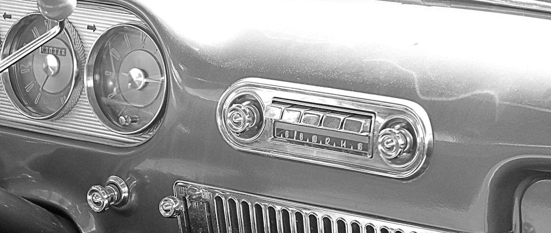 the dashboard of a green car with a radio the dashboard of a green car with a radio