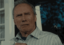 Man holding a coffee cup feeling disgusted