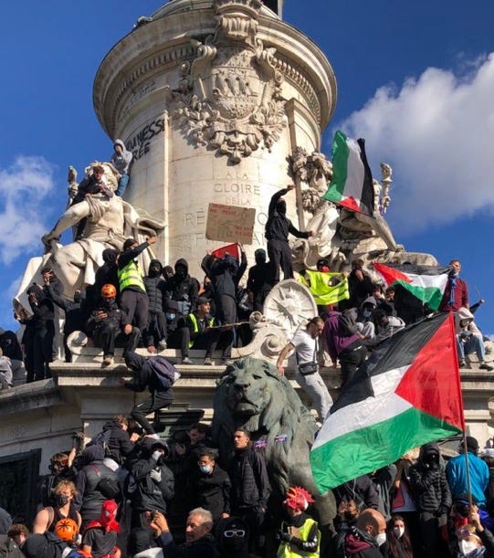 Protesters on the Monument à la République, Paris, with Palestinian flags Protesters on the Monument à la République, Paris, with Palestinian flags