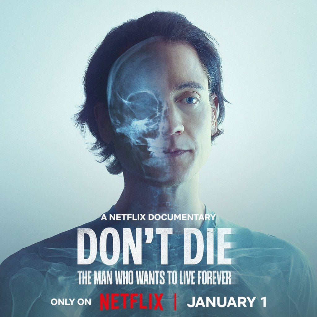 The image is a promotional poster for a Netflix documentary titled "Don't Die" featuring Bryan Johnson, who is known for his pursuit of longevity and anti-aging. The poster shows a man with a partially transparent face revealing a skull, symbolizing the theme of mortality and the quest for eternal life. The text on the poster reads "A NETFLIX DOCUMENTARY" at the top, followed by the title "DON'T DIE" in bold letters, and the subtitle "THE MAN WHO WANTS TO LIVE FOREVER" below it. The release date is prominently displayed as "ONLY ON NETFLIX | JANUARY 1". The background is a gradient of light colors, giving a serene yet eerie feel to the image. The post text from Bryan Johnson indicates that the documentary will be available on Netflix starting January 1, 2025, emphasizing the theme of not dying.