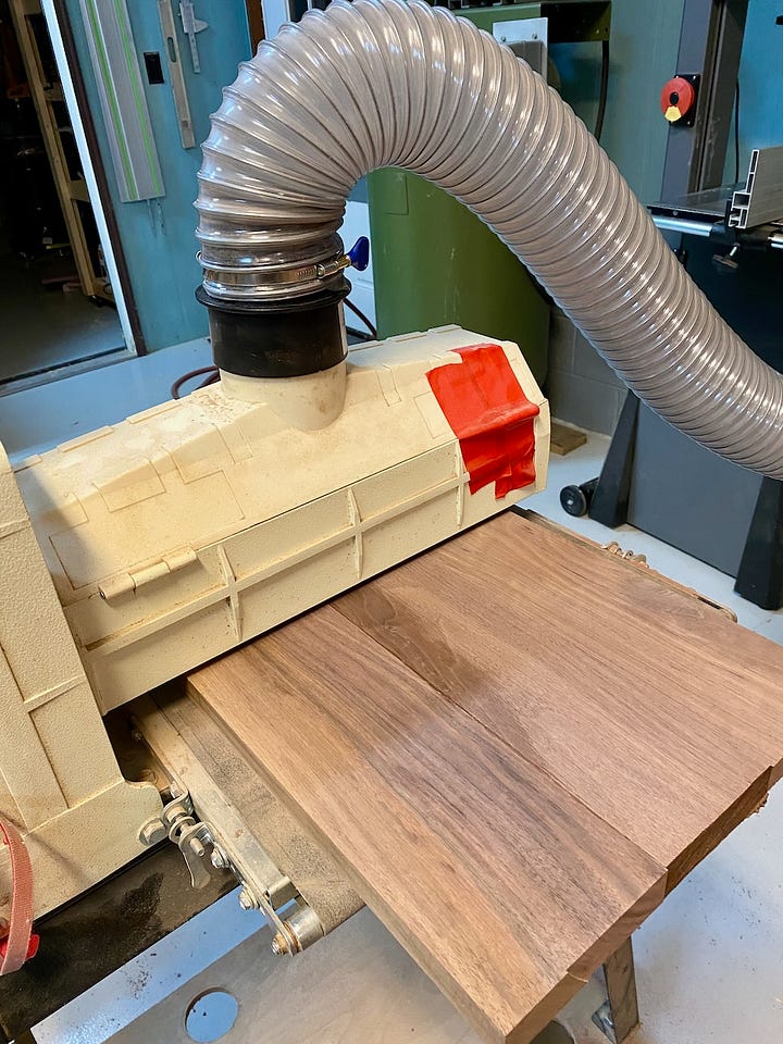 The seat runs through the drum sander to smooth and flatten. Then, upside down with beveled edges, I lay out the location of the base.