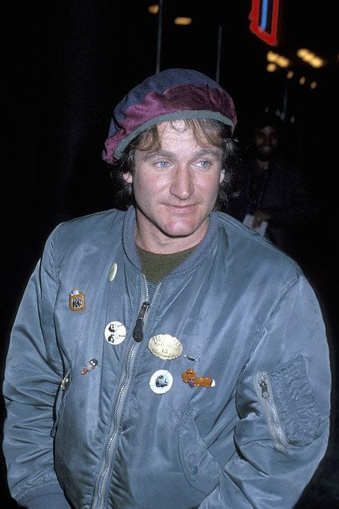 This may contain: a man wearing a jacket and hat with buttons on it