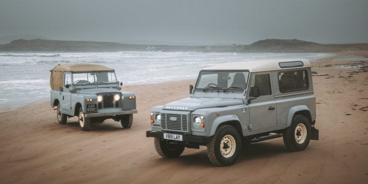 Land Rover Defender Works V8 Islay Edition on beach with original Series 2a Land Rover Defender Works V8 Islay Edition on beach with original Series 2a