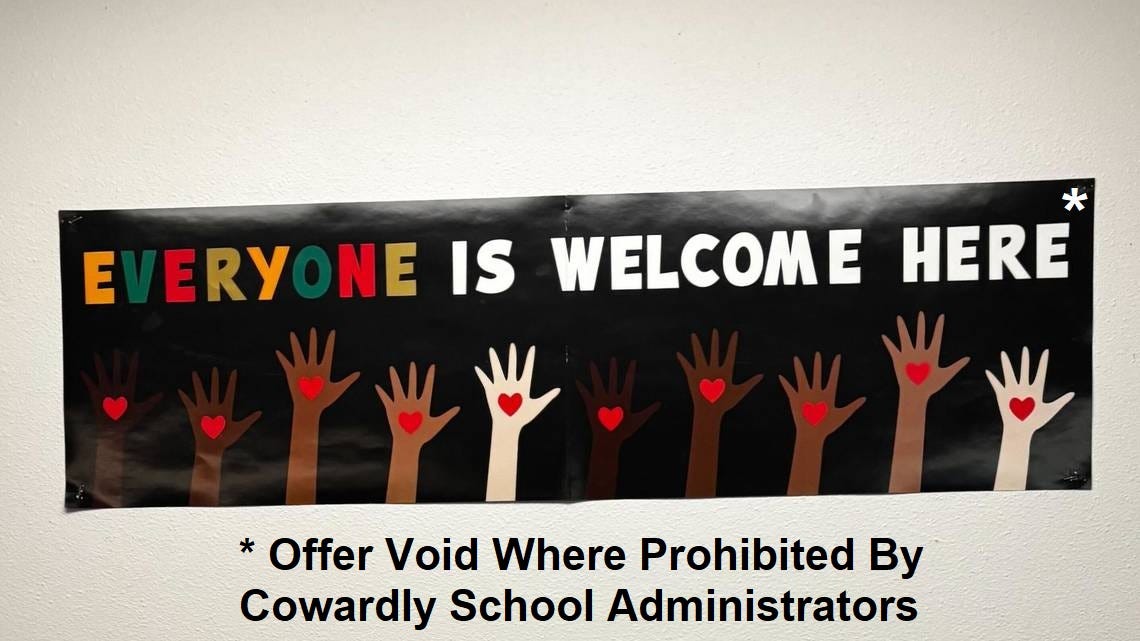 Photo of a classroom poster reading 'Everyone is welcome here!' Below the text is art showing ten hands raised, as in a class, in a variety of skin tones; each hand has a red heart drawn on it.  We have digitally added an asterisk above the text, and below the poster, the explanation '* Offer Void Where Prohibited By Cowardly School Administrators'