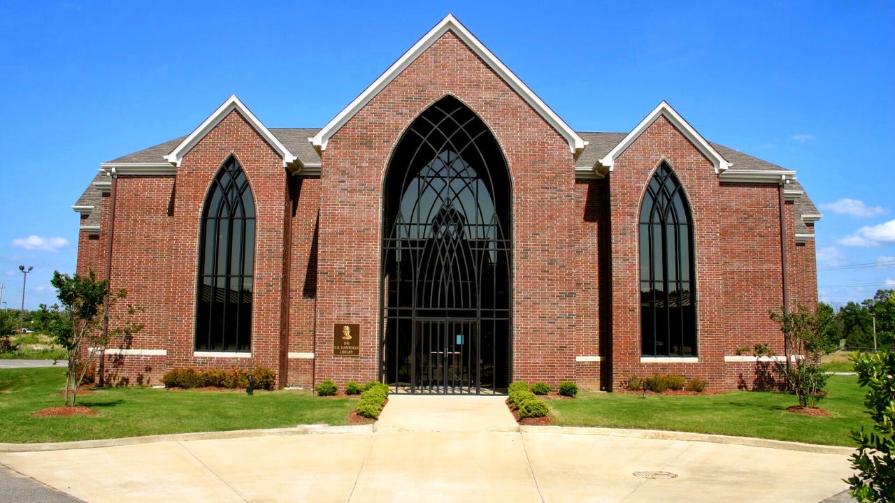 A brick building under a blue sky.