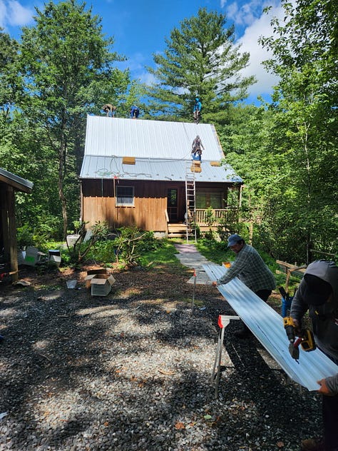 Photos of the WoolTribe Studio Cabin renovation project, showing a cabin with new standing seam metal roof, as well as interior shots of the studio with new drop ceiling tiles.