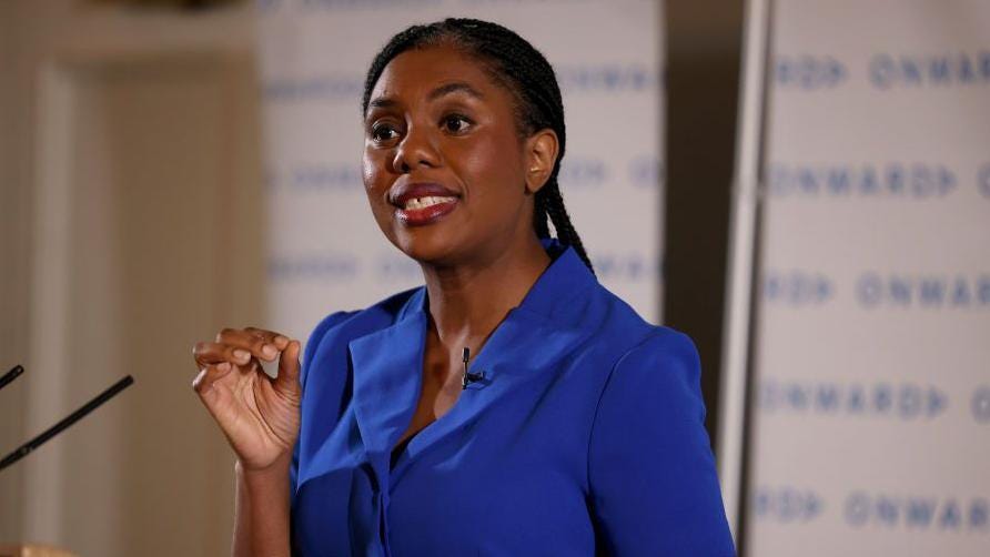 Conservative Party Leader Kemi Badenoch, wearing a blue dress, gesticulates to punctuate her speech from behind a lectern on how the Conservative party can rebuild voter Conservative Party Leader Kemi Badenoch, wearing a blue dress, gesticulates to punctuate her speech from behind a lectern on how the Conservative party can rebuild voter