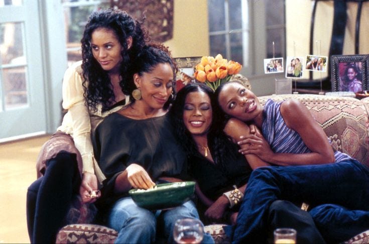 This may contain: three women are sitting on a couch and smiling