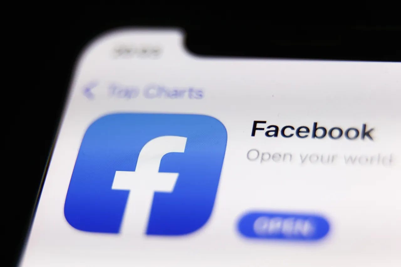Tela de um iPhone desfocada com o icone do Facebook com foco e destaque