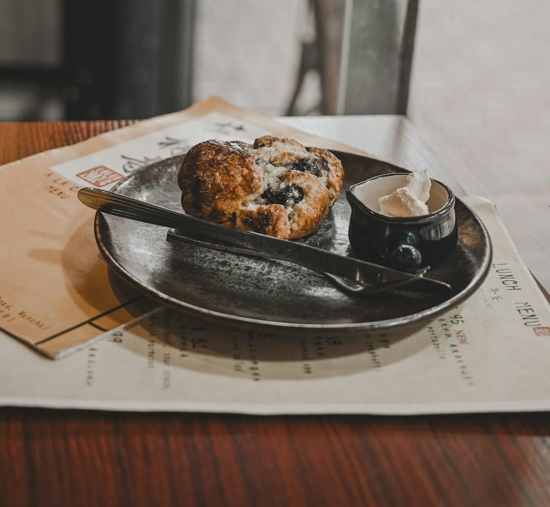 brown and white pastry on black ceramic plate brown and white pastry on black ceramic plate