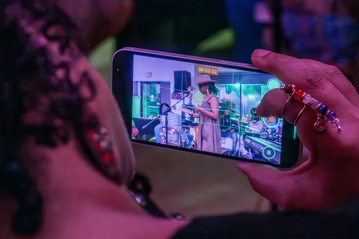 Audience member films a performance at Blondie Mansion Week-End on their phone. Audience member films a performance at Blondie Mansion Week-End on their phone.