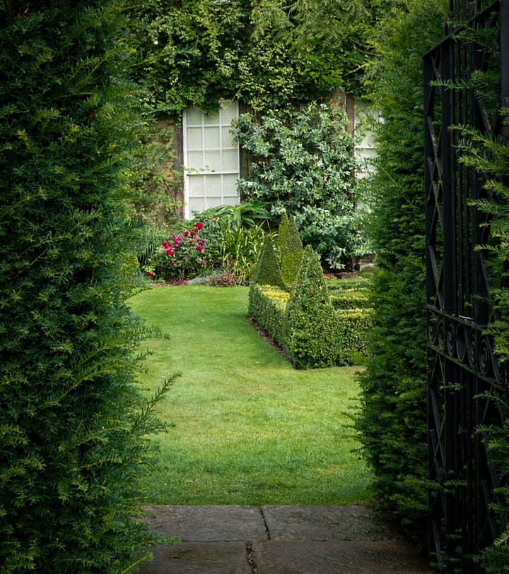 a tranquil oasis of neatly trimmed hedges and vibrant blooms