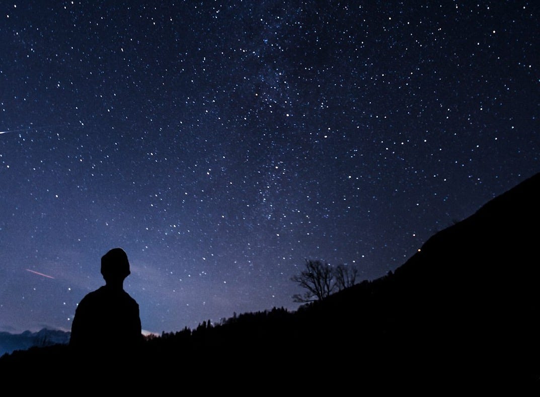 silhouette of man looking at milky way silhouette of man looking at milky way