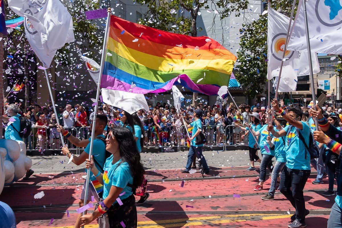 The author carrying a rainbow flag with the Salesforce contingent at the SF Pride parade in 2019