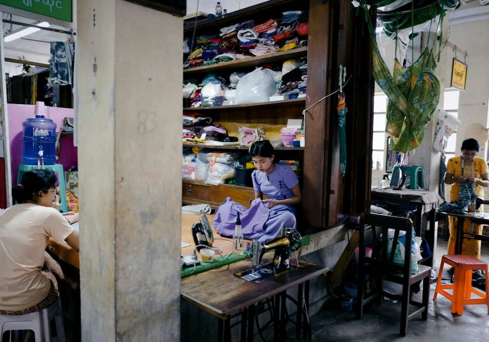Asian women making clothing in a factory Asian women making clothing in a factory