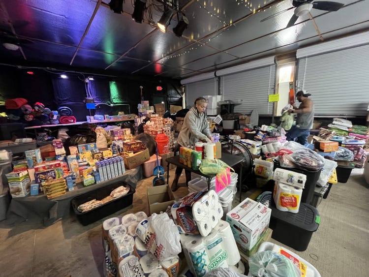 Alex Holt unpacking and sorting donated goods for hurricane victims. RCI